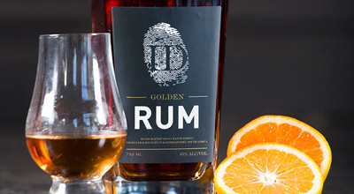 sipping golden rum from Incendo Distillery